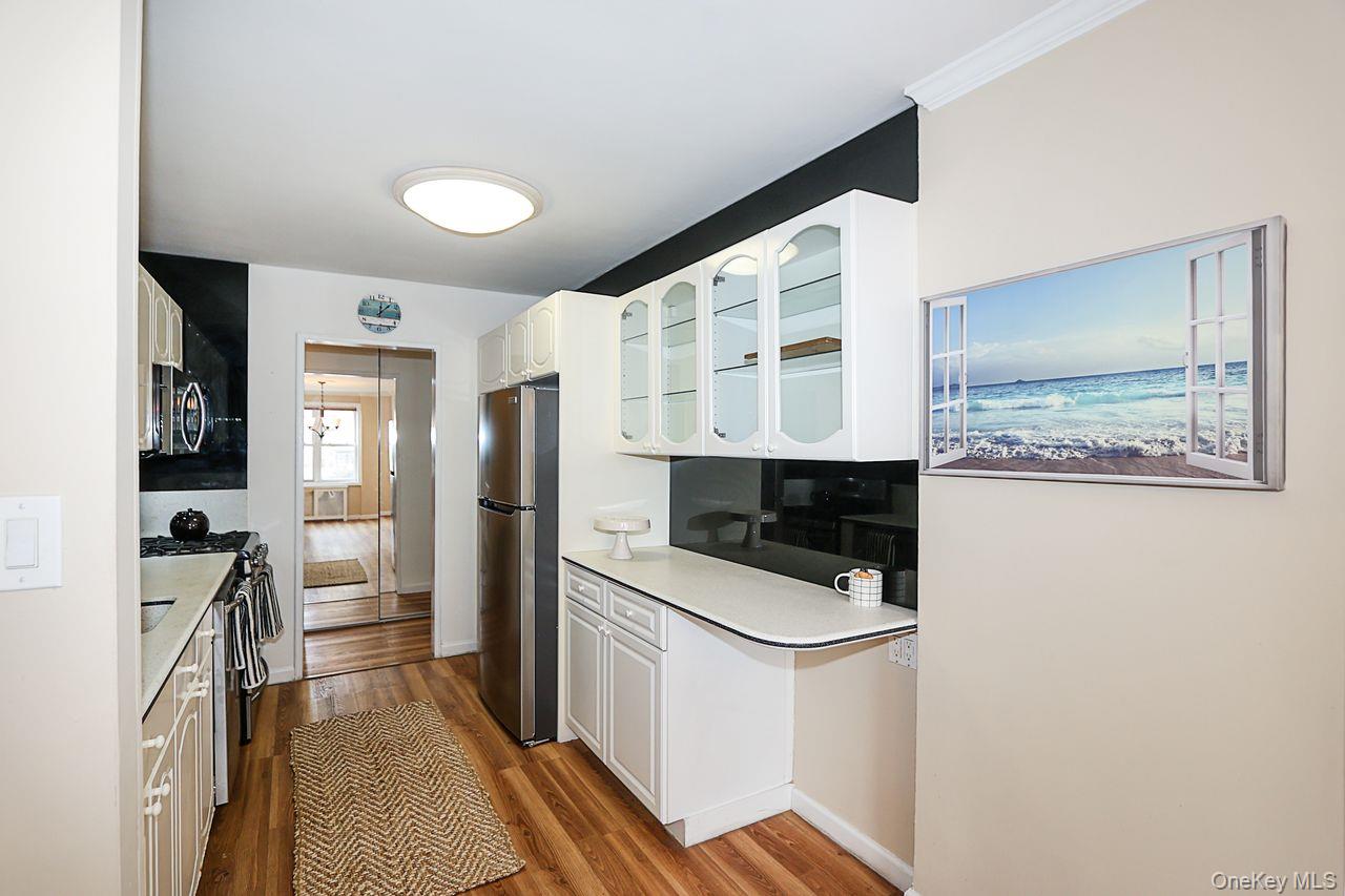 522 Shore Road, Unit 1D Long Beach, NY 11561 - Photo 8 of 22 a kitchen with stainless steel appliances a refrigerator and a stove
