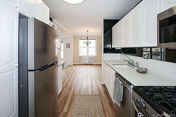 522 Shore Road, Unit 1D Long Beach, NY 11561 - Photo 9 of 22 a kitchen with a sink appliances and cabinets