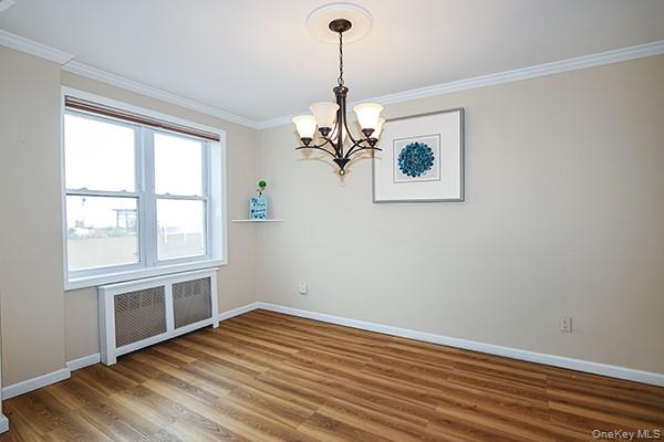 522 Shore Road, Unit 1D Long Beach, NY 11561 - Photo 10 of 22 a view of a room with wooden floor chandelier and windows
