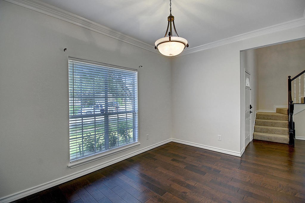 5101 Cavendish Drive Corpus Christi, TX 78413 - Photo 13 of 40 a view of an empty room with wooden floor and a window