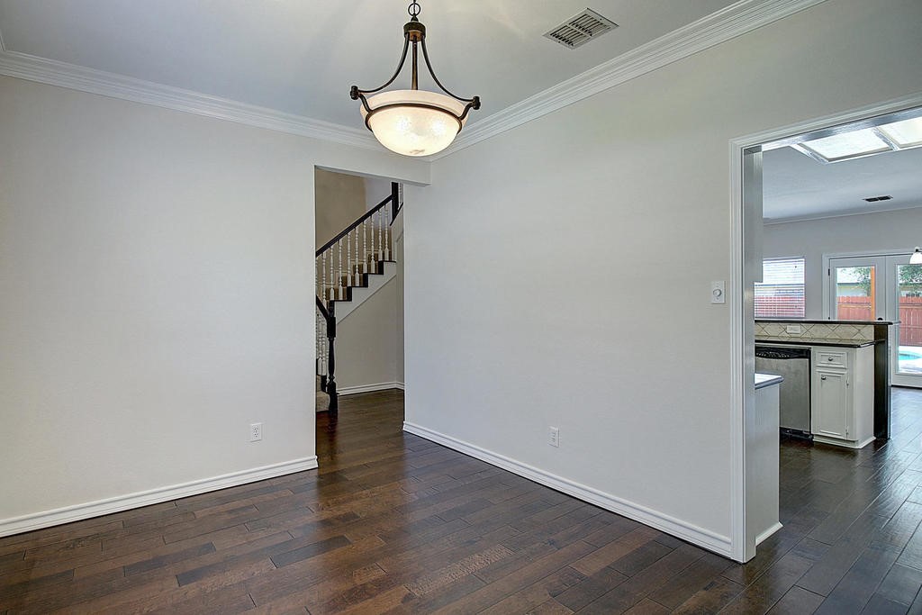 5101 Cavendish Drive Corpus Christi, TX 78413 - Photo 14 of 40 an empty room with wooden floor and windows