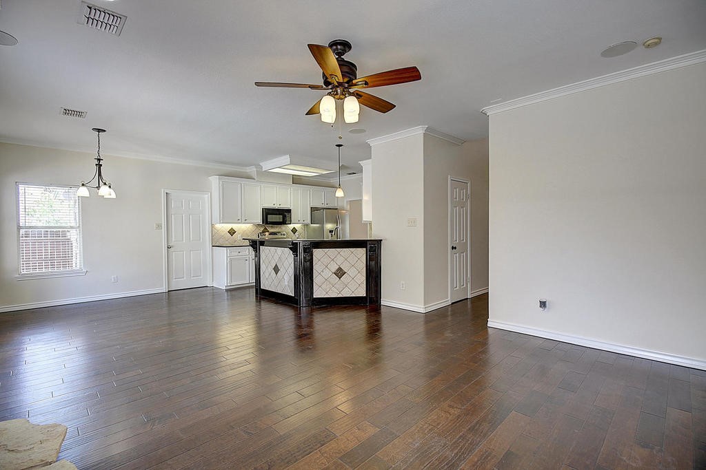 5101 Cavendish Drive Corpus Christi, TX 78413 - Photo 16 of 40 a view of a kitchen with a sink dishwasher a refrigerator and wooden floor