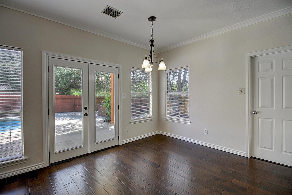 5101 Cavendish Drive Corpus Christi, TX 78413 - Photo 17 of 40 a view of an empty room with wooden floor and a window