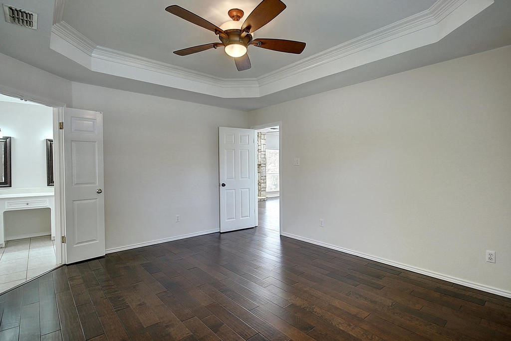 5101 Cavendish Drive Corpus Christi, TX 78413 - Photo 26 of 40 an empty room with wooden floor a ceiling fan and windows