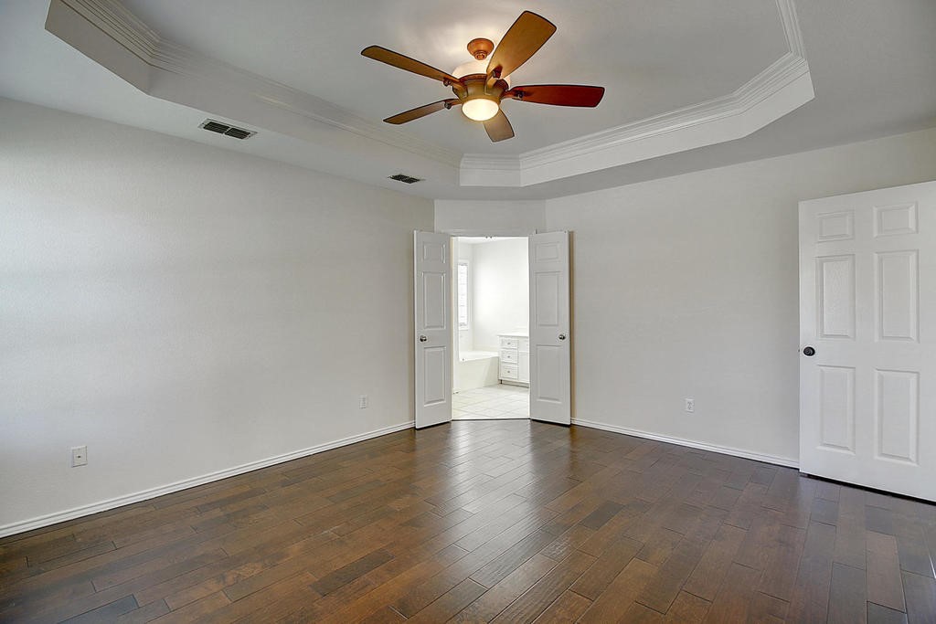 5101 Cavendish Drive Corpus Christi, TX 78413 - Photo 27 of 40 a view of an empty room with window a ceiling fan and wooden floor