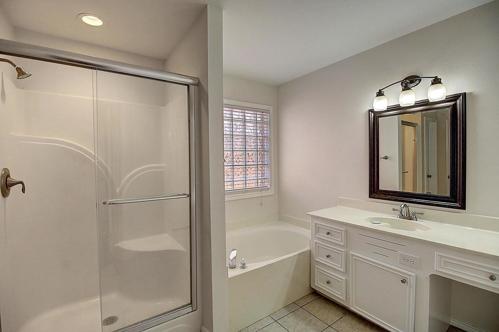 5101 Cavendish Drive Corpus Christi, TX 78413 - Photo 28 of 40 a bathroom with a bathtub shower sink and mirror
