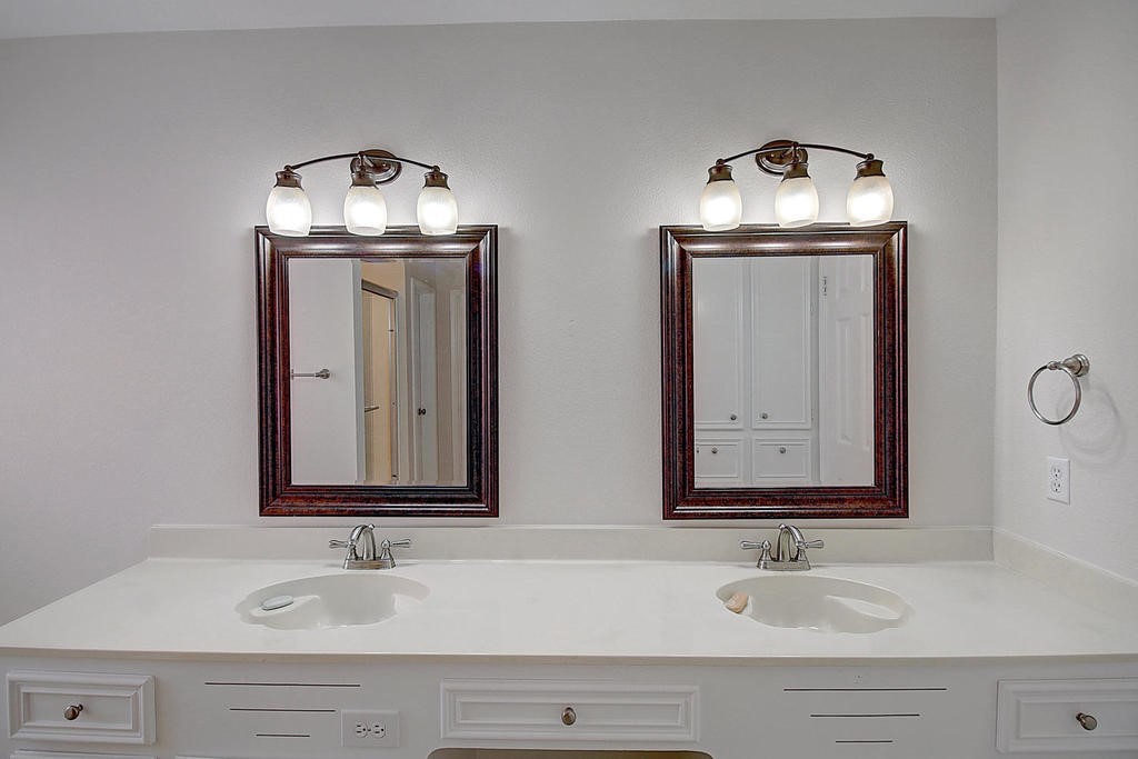 5101 Cavendish Drive Corpus Christi, TX 78413 - Photo 29 of 40 a bathroom with double vanity sinks and a mirror