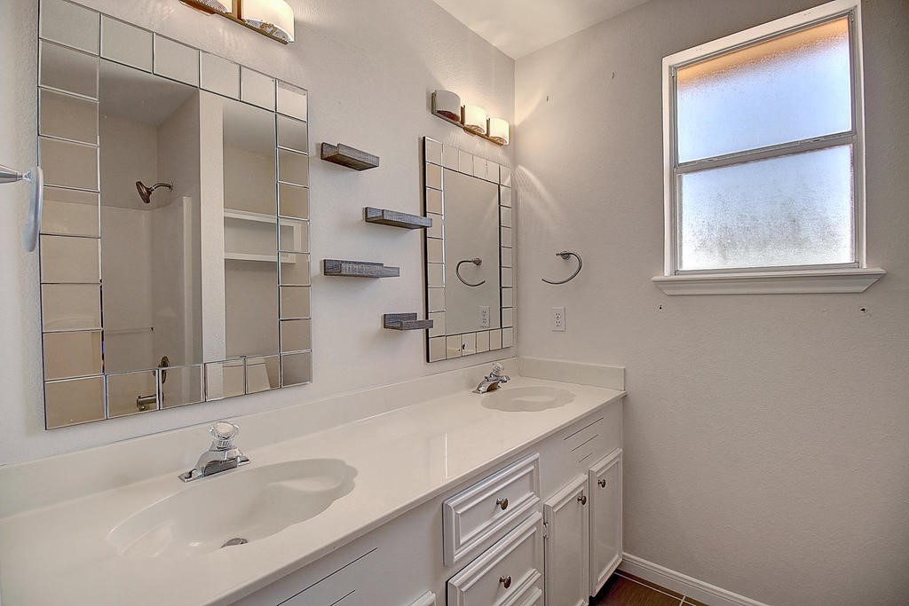 5101 Cavendish Drive Corpus Christi, TX 78413 - Photo 35 of 40 a bathroom with a shower sink and mirror