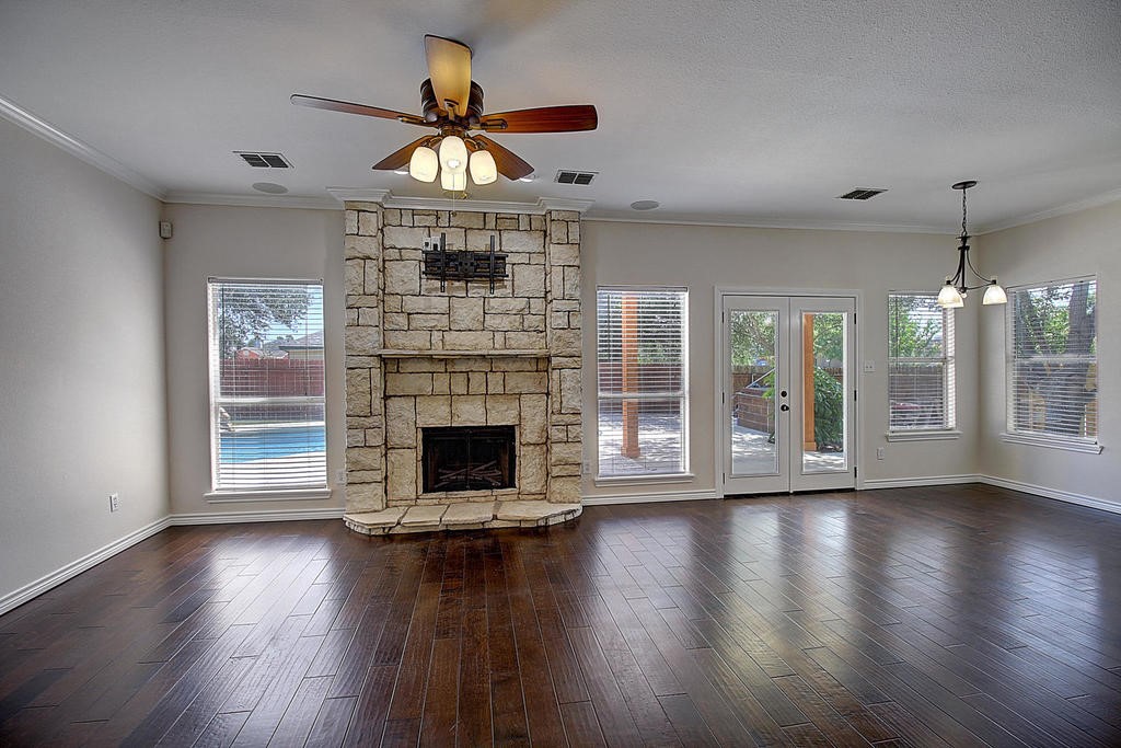5101 Cavendish Drive Corpus Christi, TX 78413 - Photo 5 of 40 a view of a livingroom with fireplace wooden floor and windows