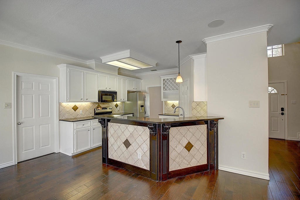 5101 Cavendish Drive Corpus Christi, TX 78413 - Photo 6 of 40 a kitchen with stainless steel appliances a white stove top oven and a refrigerator