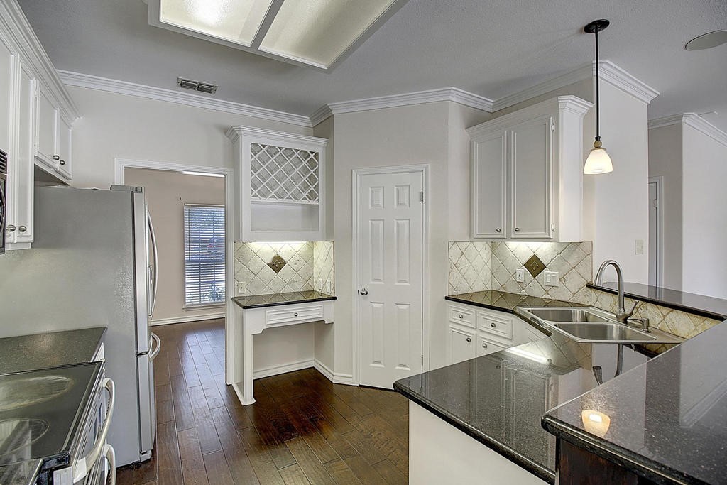 5101 Cavendish Drive Corpus Christi, TX 78413 - Photo 8 of 40 a kitchen with stainless steel appliances granite countertop a sink a stove and a wooden floors