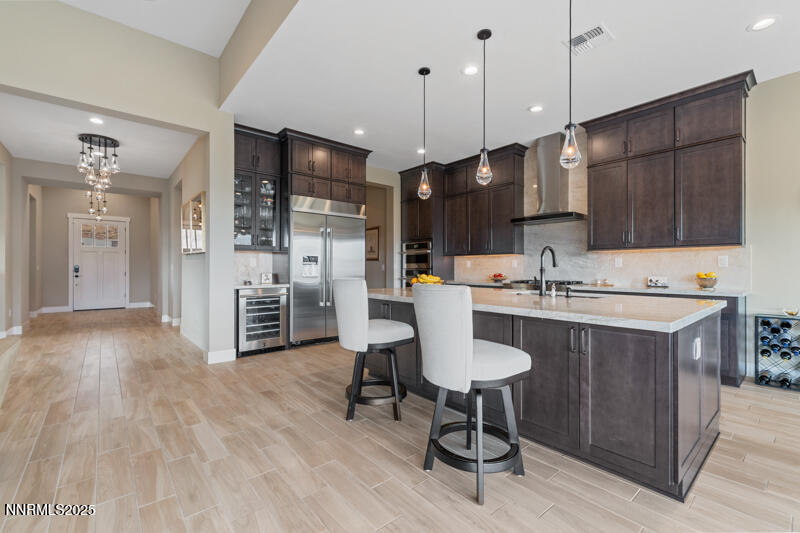 8900 Suncreek Court Reno, NV 89523 - Photo 14 of 74 a kitchen with stainless steel appliances kitchen island granite countertop a sink refrigerator and cabinets