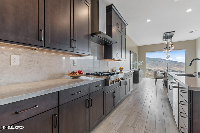8900 Suncreek Court Reno, NV 89523 - Photo 17 of 74 a kitchen with stainless steel appliances granite countertop a lot of counter space and wooden floors