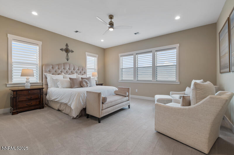 8900 Suncreek Court Reno, NV 89523 - Photo 27 of 74 a spacious bedroom with a bed and a couch