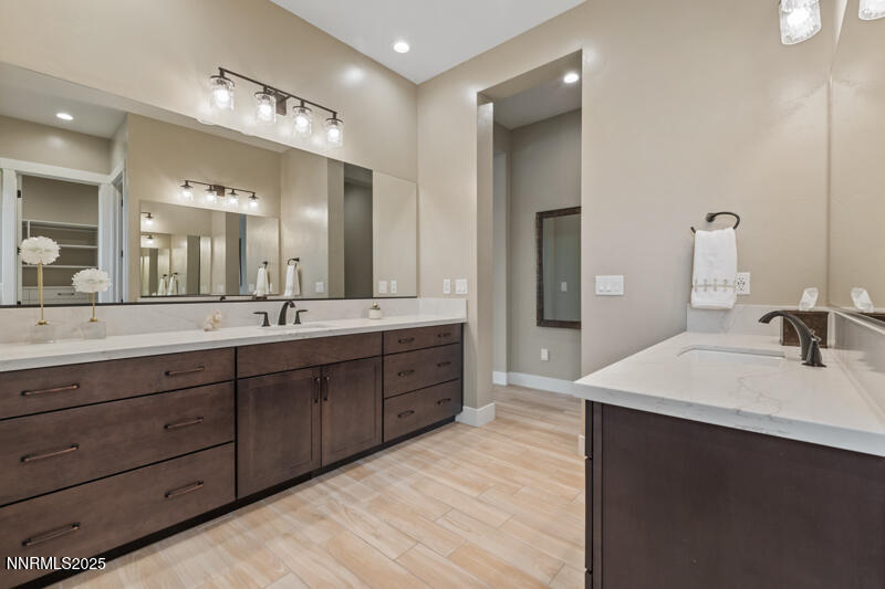 8900 Suncreek Court Reno, NV 89523 - Photo 30 of 74 a spacious bathroom with a double vanity sink and a mirror
