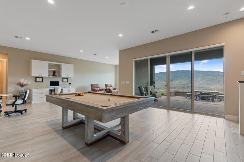 8900 Suncreek Court Reno, NV 89523 - Photo 39 of 74 a dining hall with stainless steel appliances a stove a table and chairs with wooden floor