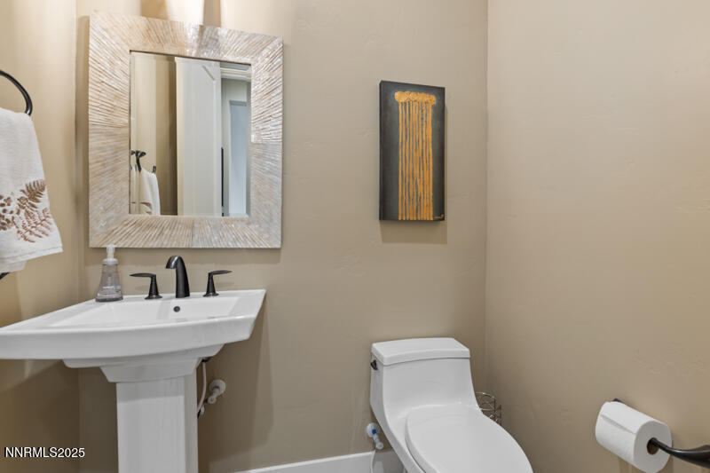 8900 Suncreek Court Reno, NV 89523 - Photo 44 of 74 a bathroom with a toilet sink and mirror