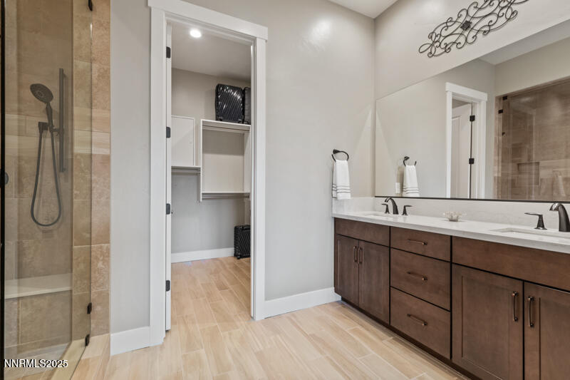 8900 Suncreek Court Reno, NV 89523 - Photo 46 of 74 a bathroom with a double vanity sink and mirror