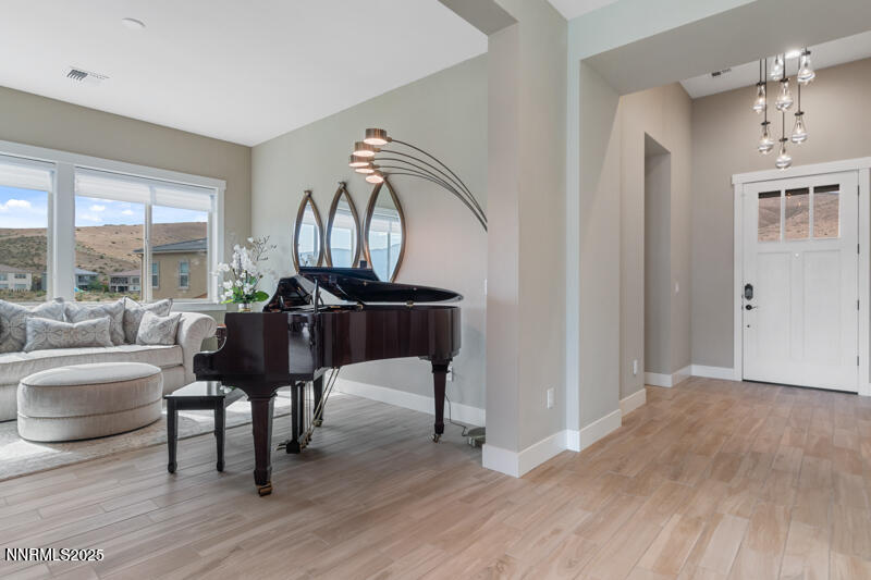 8900 Suncreek Court Reno, NV 89523 - Photo 9 of 74 a living room with furniture a large window and wooden floor