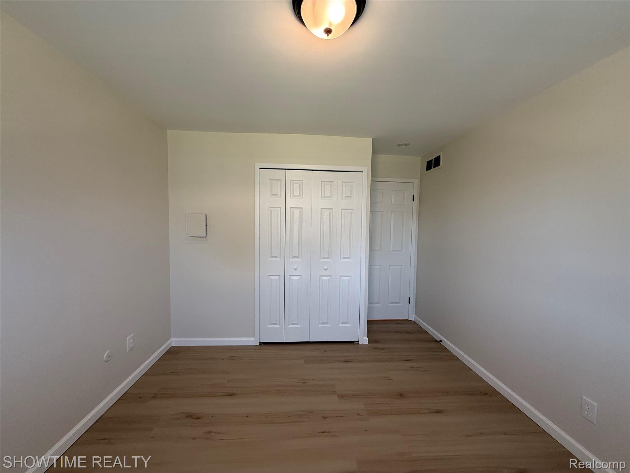 29141 Hayes Road Warren, MI 48088 - Photo 12 of 18 Wood-finish flooring with white baseboards