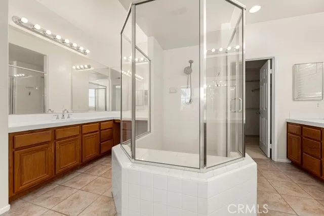 a bathroom with a double vanity sink and mirror
