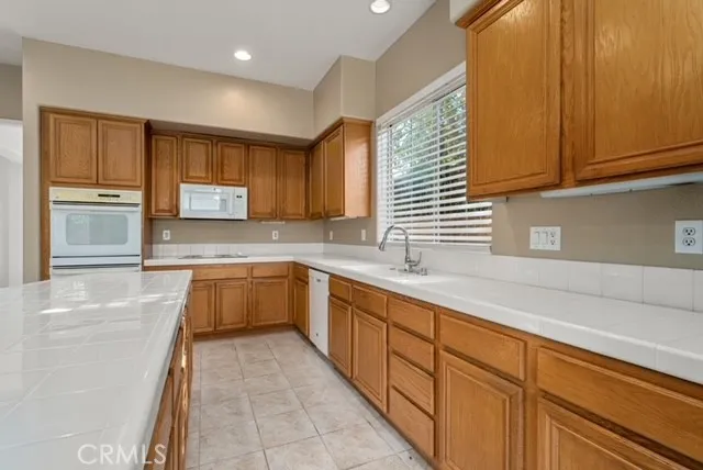 a kitchen with stainless steel appliances granite countertop a sink and cabinets
