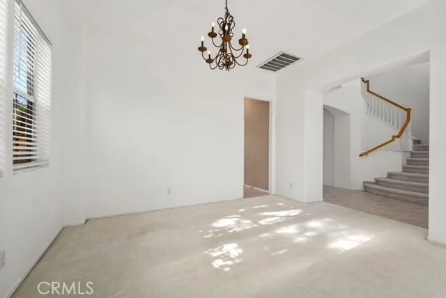 a view of a chandelier fan and window