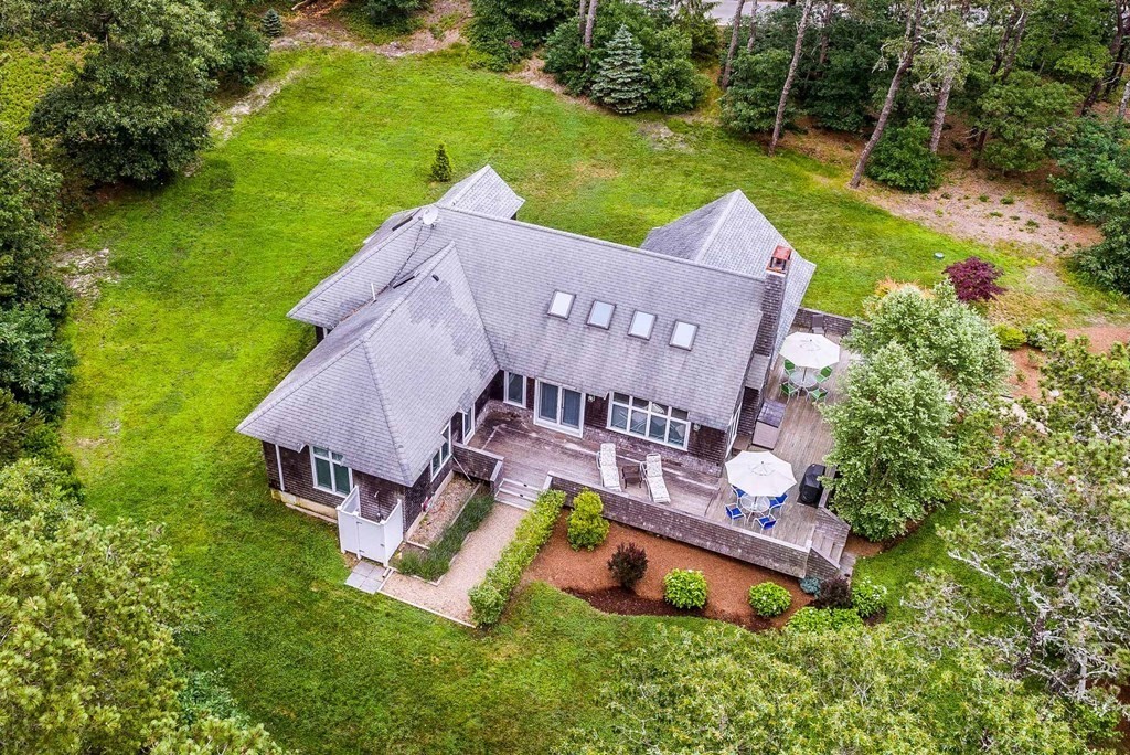 an aerial view of a house with swimming pool garden and patio