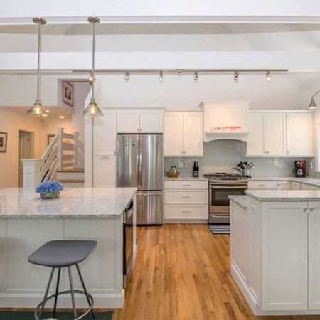 10 Codman Spring Road Edgartown, MA 02539 - Photo 11 of 32 a kitchen with kitchen island white cabinets and stainless steel appliances