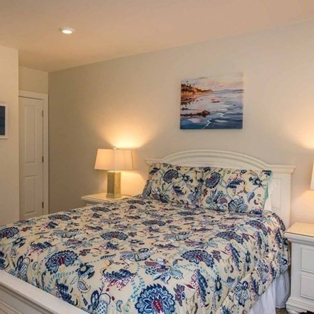 10 Codman Spring Road Edgartown, MA 02539 - Photo 17 of 32 a bedroom with a bed and a lamp