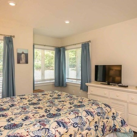 10 Codman Spring Road Edgartown, MA 02539 - Photo 21 of 32 a bedroom with a bed and a flat screen tv