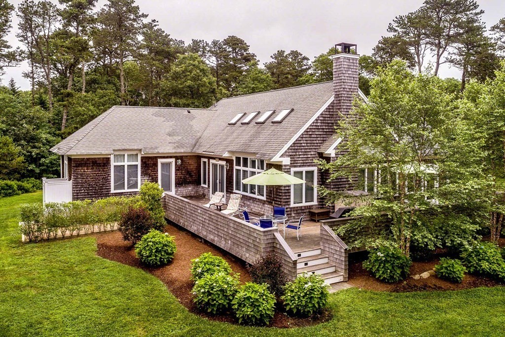 10 Codman Spring Road Edgartown, MA 02539 - Photo 3 of 32 a aerial view of a house with a yard table and chairs