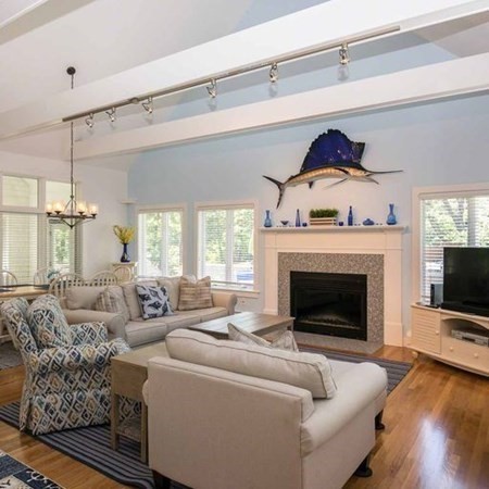 10 Codman Spring Road Edgartown, MA 02539 - Photo 9 of 32 a living room with furniture a flat screen tv and a fireplace