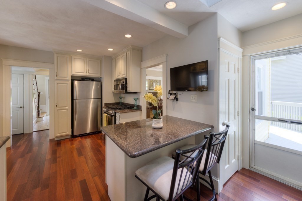 46 Eagle Road Worcester, MA 01605 - Photo 13 of 42 a kitchen with stainless steel appliances granite countertop a table chairs refrigerator and sink