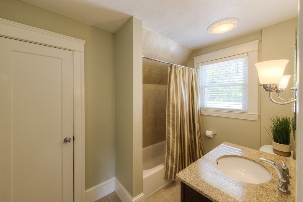 46 Eagle Road Worcester, MA 01605 - Photo 24 of 42 a bathroom with a granite countertop sink and a mirror