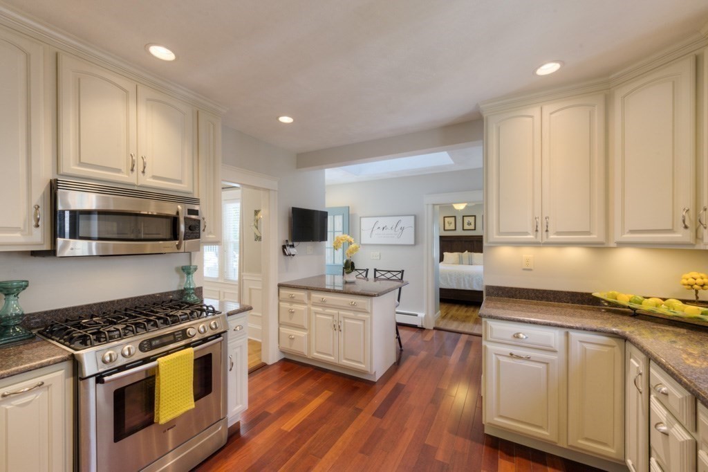 46 Eagle Road Worcester, MA 01605 - Photo 10 of 42 a kitchen with stainless steel appliances granite countertop a stove top oven a sink dishwasher and white cabinets with wooden floor