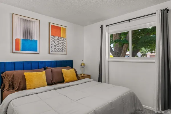 a bedroom with a large bed and a window