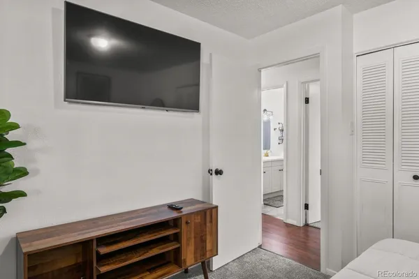 a view of a livingroom with wooden floor and windows