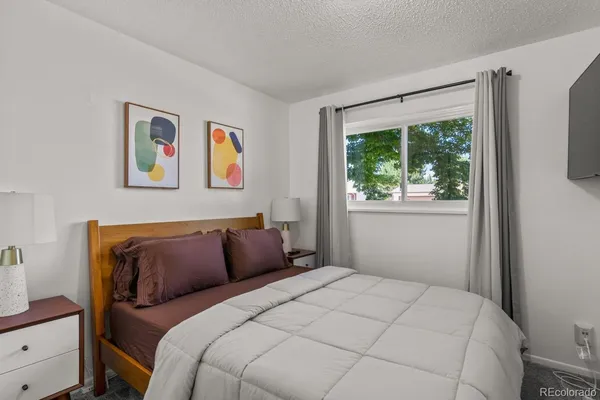 a bedroom with a bed and a window