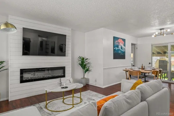 a living room with furniture kitchen view and a fireplace