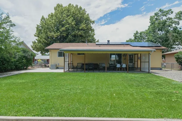a view of a house with a backyard