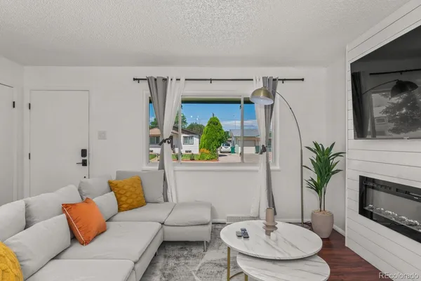 a living room with furniture and a fireplace