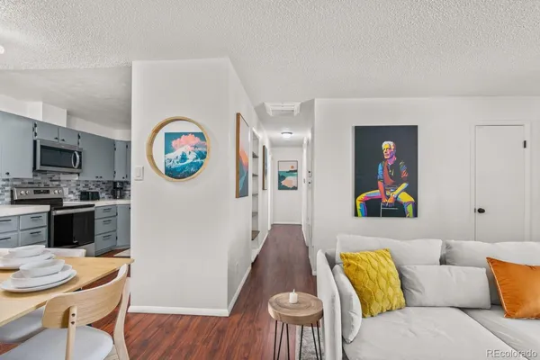 a living room with furniture and a wooden floor