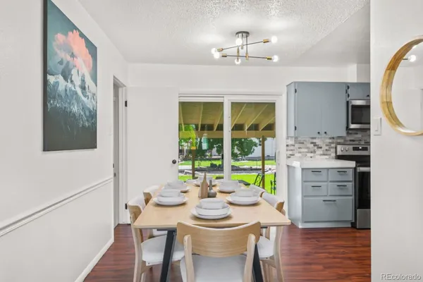 a view of a dining room with furniture and a chandelier