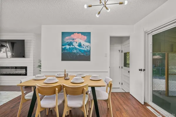 a view of a dining room with furniture and wooden floor