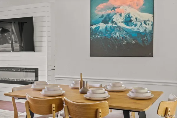 a dining room with furniture and a fireplace