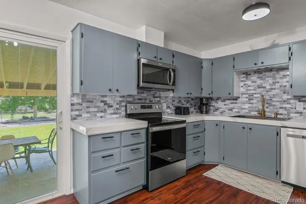 a kitchen with a sink stove and cabinets
