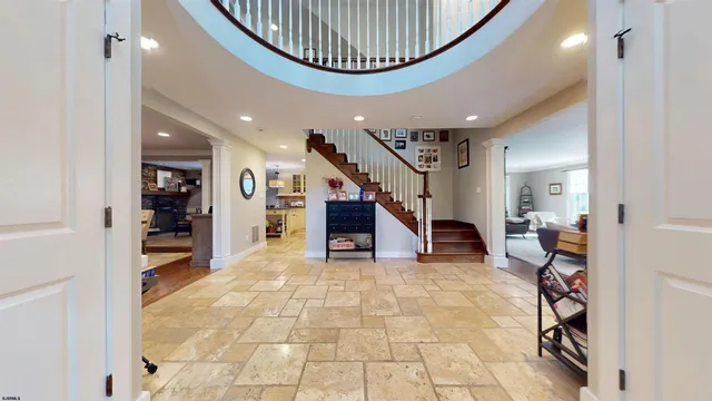 a view of entryway with wooden floor and windows