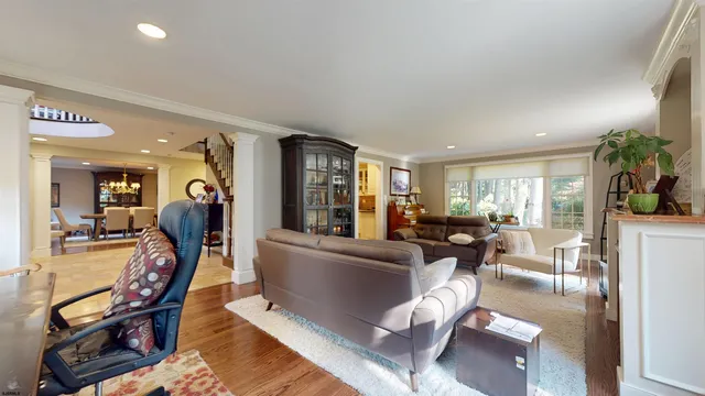 a bathroom with a sink and a large mirror next to a window