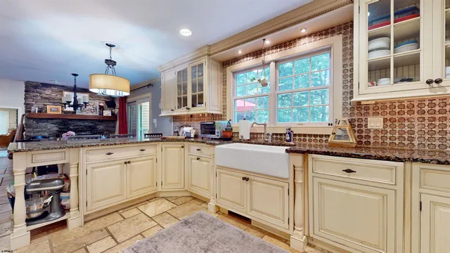 a view of a house with swimming pool and sitting area